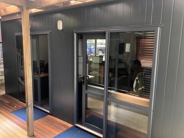 Dark charcoal coloured cabin with a deck